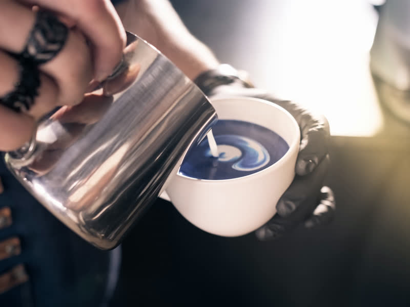 Milk being poured into a latte